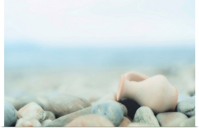 Zen composition on pebble beach, small amphora on  lies pebbles.