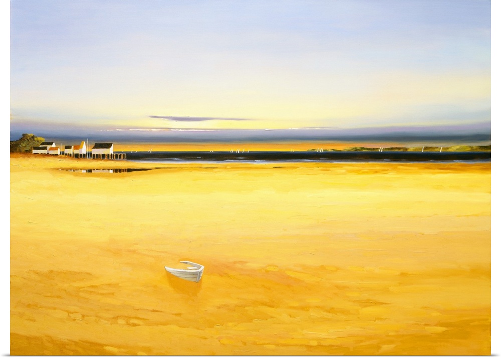 Seascape in the late afternoon with golden water and houses in the distance.