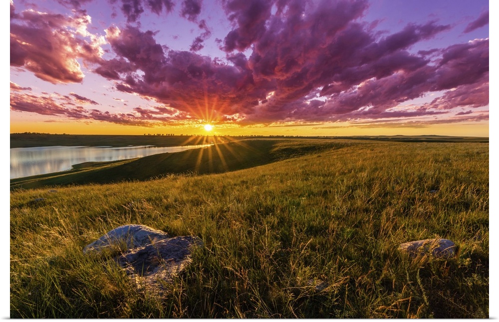 Sunset over South Dakota's Lake Oahe is spectacular, with clouds turned crimson and beautiful light cast over the rolling ...
