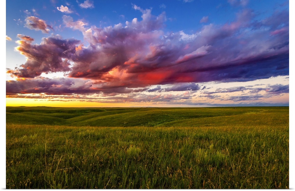 The setting casts beautiful colors into the clouds over the plains near Pierre, South Dakota. Time spent watching these su...