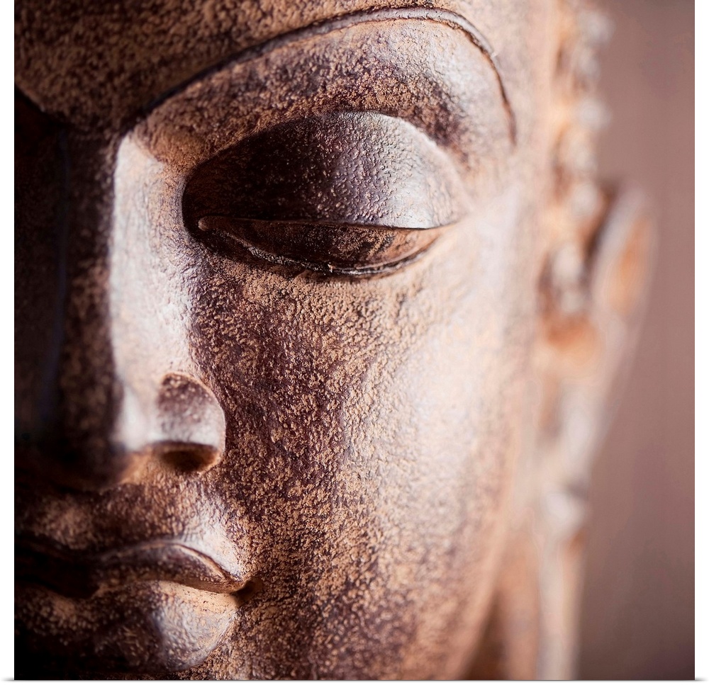 Square close up photograph of a Buddha statue.