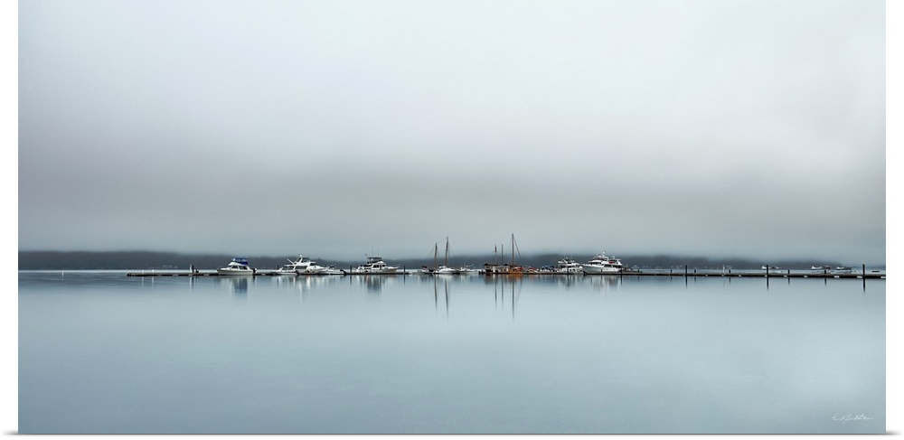 Fog blankets boats and float planes at the Alderbrook Marina just as the sunrises for the day.