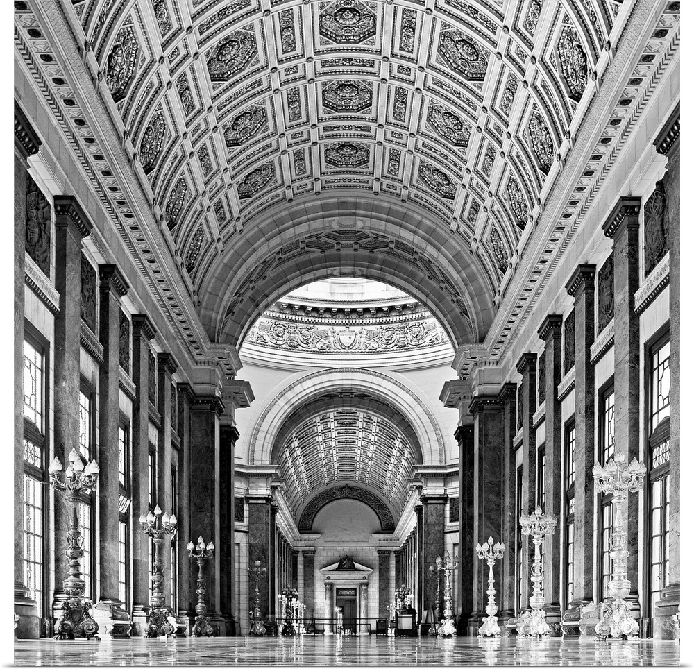 A black and white photograph of the interior of a church, with arches and detailed ceilings.