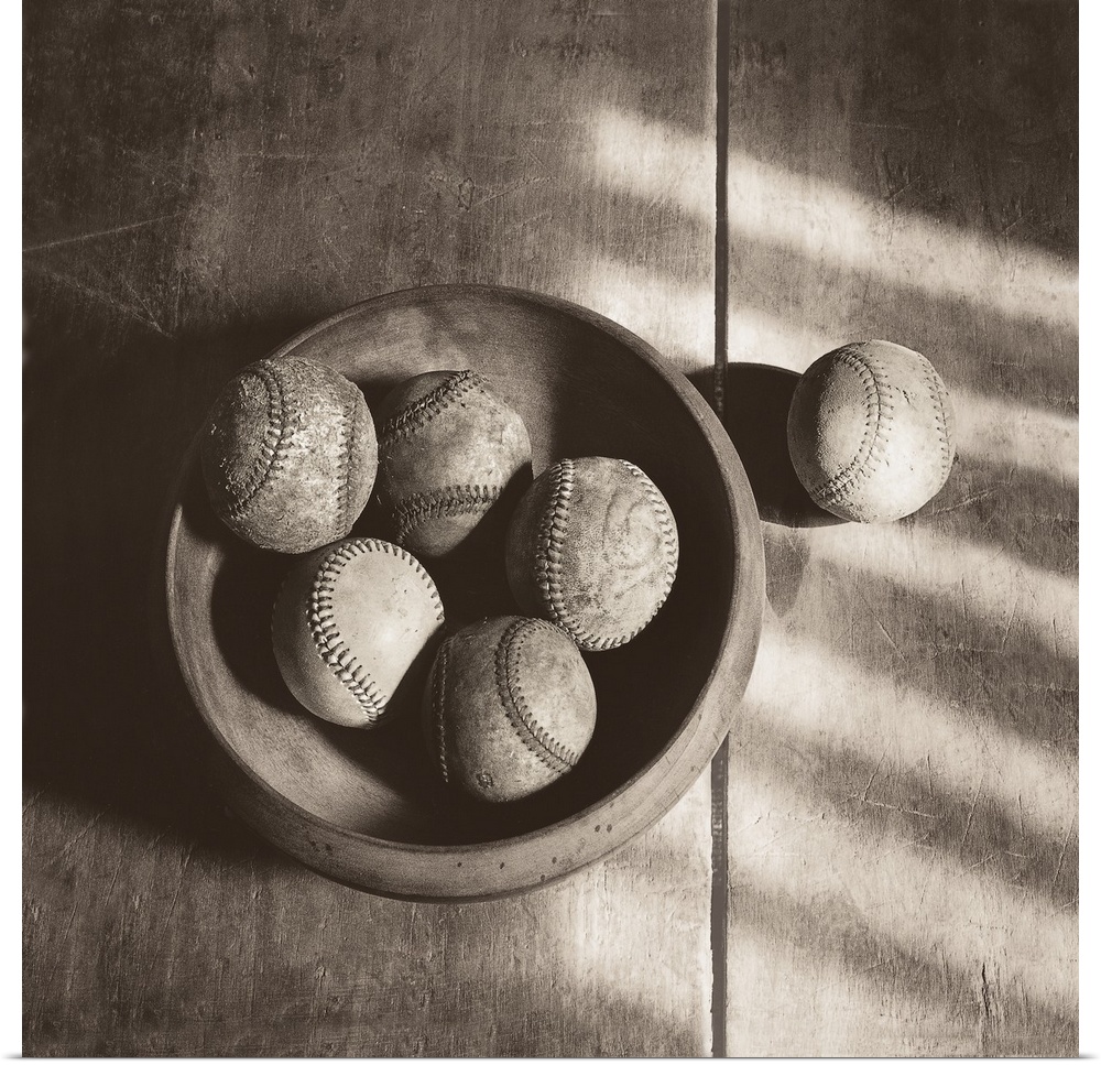 Photograph in sepia tones of a bowl of baseballs by Judy B. Messer.