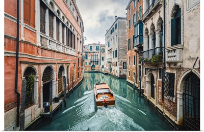 A Boat Cruising A Green Canal In Venice, Veneto, Italy