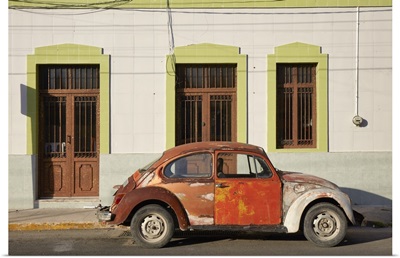A Vintage Volkswagen Beetle In Front Of A House In Merida, Yucatan, Mexico