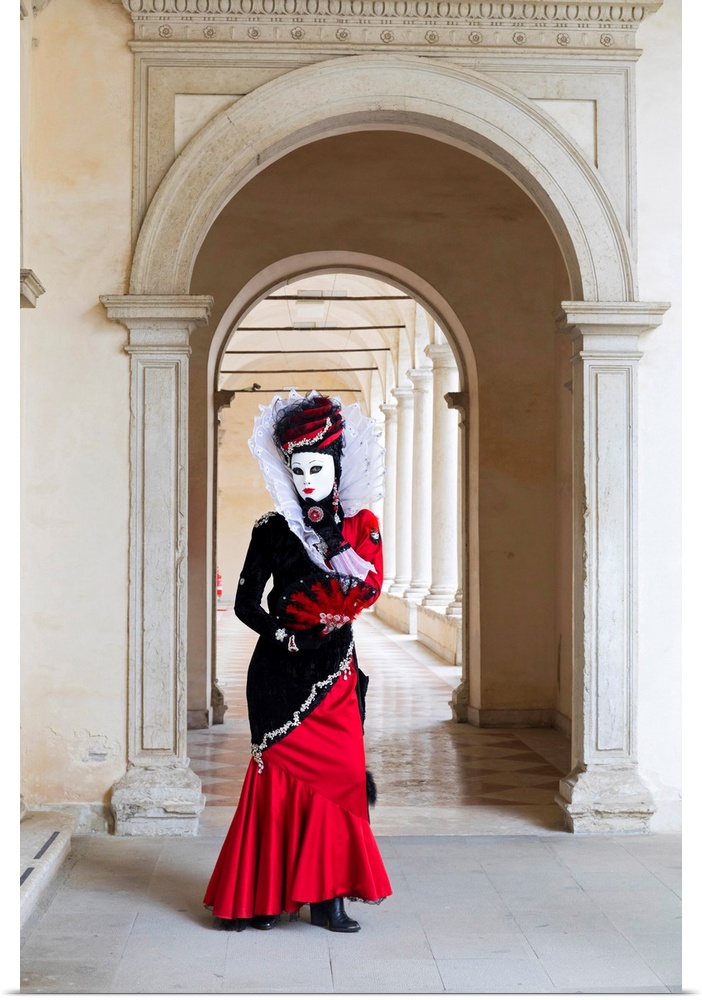 A Woman In A Red Costume And Mask Poses In An Archway During The Venice Carnival, Venice, Italy