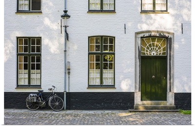 Belgium, Bruges. Bicycle next to a house in the Begijnhof (Beguinage) of Bruges