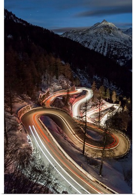 Car lights on the curvy Maloja Pass, Engadin, Graubunden, Switzerland