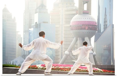China, Shanghai. Chinese men practising Tai Chi on the Bund