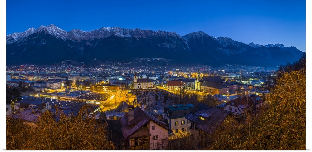 Austria, Tyrol,  Innsbruck, elevated city view with the Wilten Basilica and Wilten Abbey Church, dawn, winter