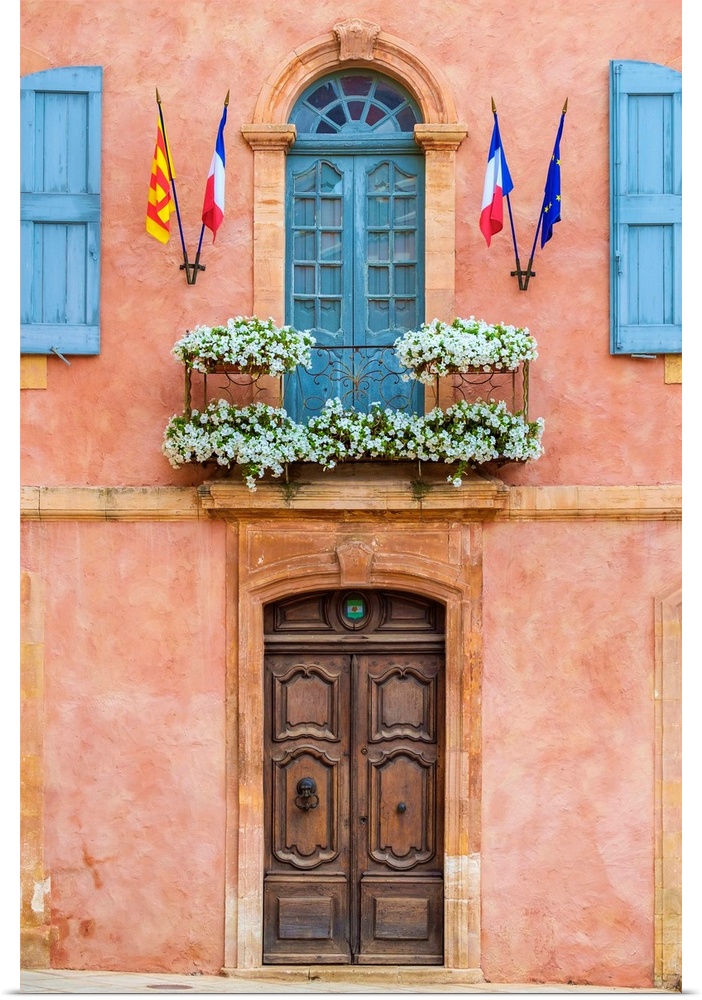 Colorful ochre colored facade of Mairie (mayor's office) in Roussillon, Vaucluse, Provence-Alpes-Cote d'Azur, France.