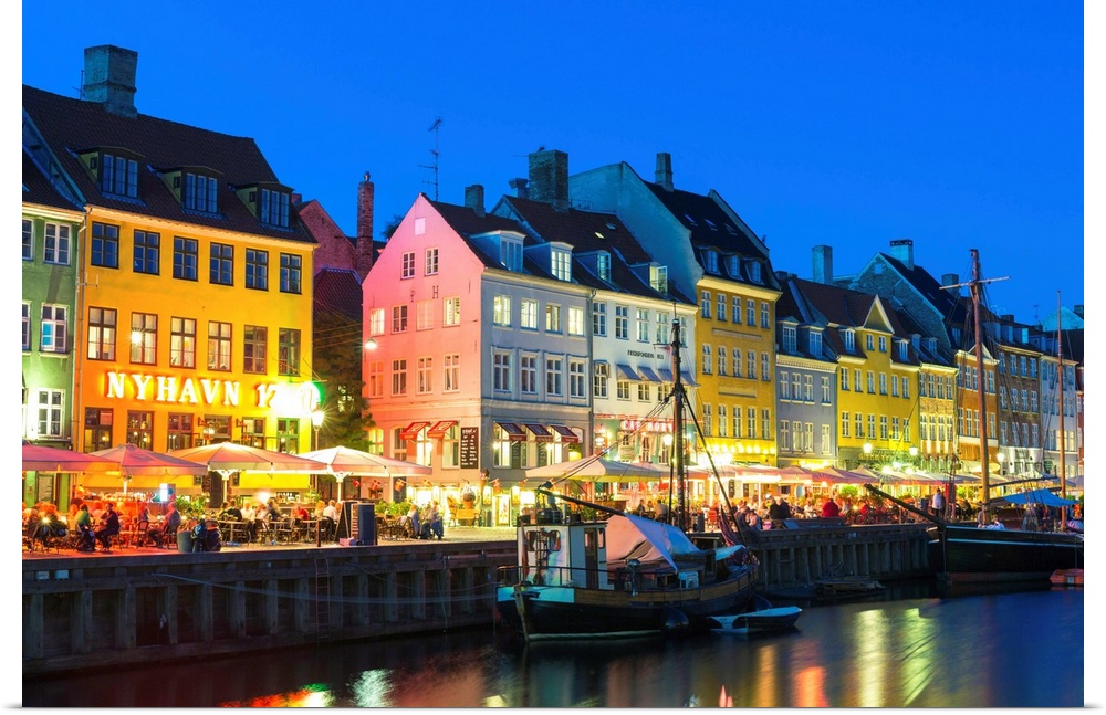 Denmark, Hillerod, Copenhagen. Colourful buildings along the 17th century waterfront of Nyhavn at dusk.