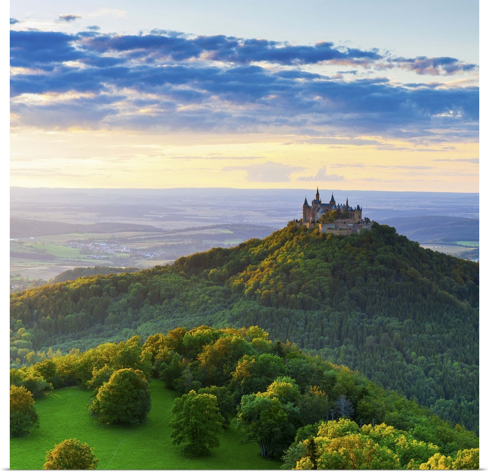 Elevated view towards Hohenzollern Castle and sourrounding countryside illuminated at sunset, Swabia, Baden Wuerttemberg, ...