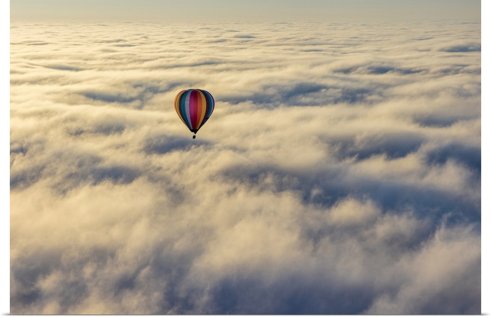 Hot air balloon above low cloud, Yarra Valley, Victoria, Australia.