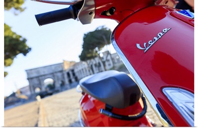 Italy, Rome, red Vespa motorbike enjoying the sunset at Colosseum and Roman Forum