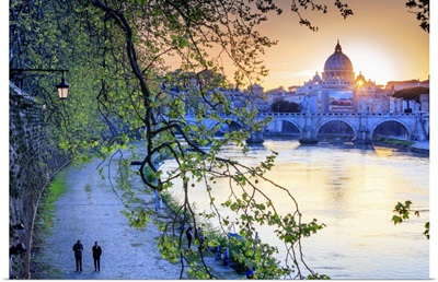 Italy, Rome, St. Peter Basilica at sunset reflecting on Tevere river