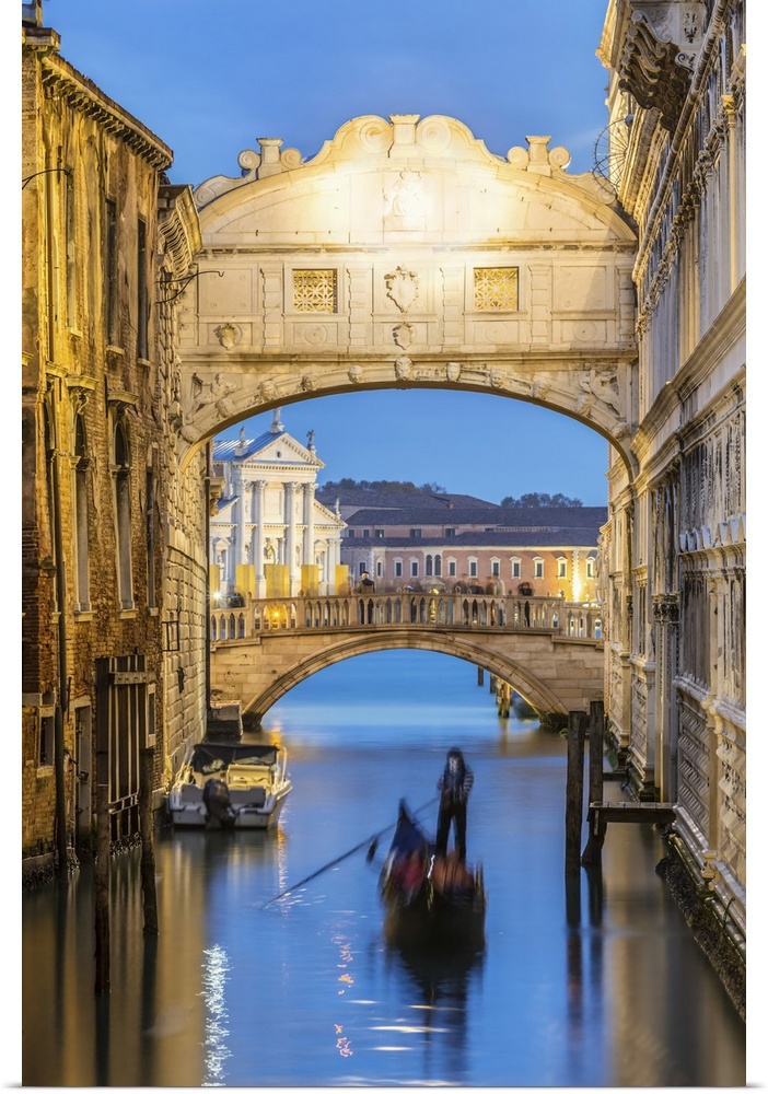Italy, Veneto, Venice. Bridge of sighs illuminated at dusk with gondolas