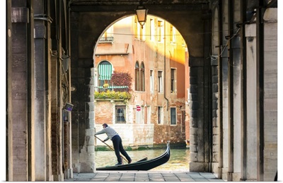 Italy, Veneto, Venice. Gondola passing on Grand canal seen from a colonnade