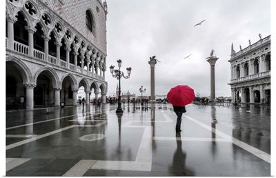 Italy, Veneto, Venice. Woman with red umbrella in front of Doges palace