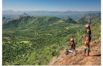 Kenya, Samburu warriors pause to look for livestock on the Kirimun escarpment