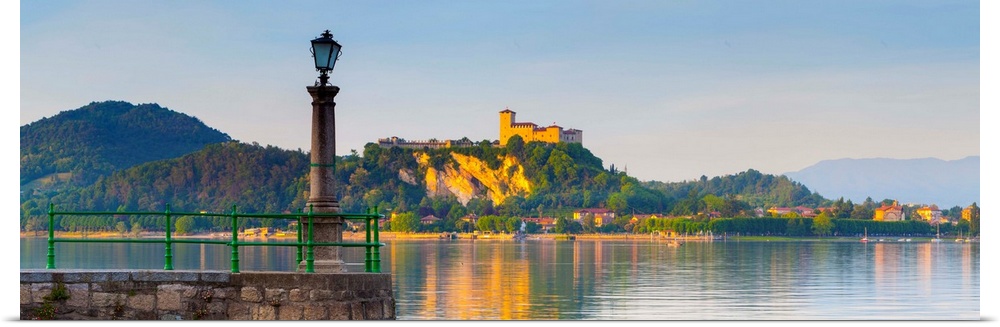 The imposing La Rocca fortress viewd from Arona at sunset, Lake Maggiore, Piedmont, Italy.