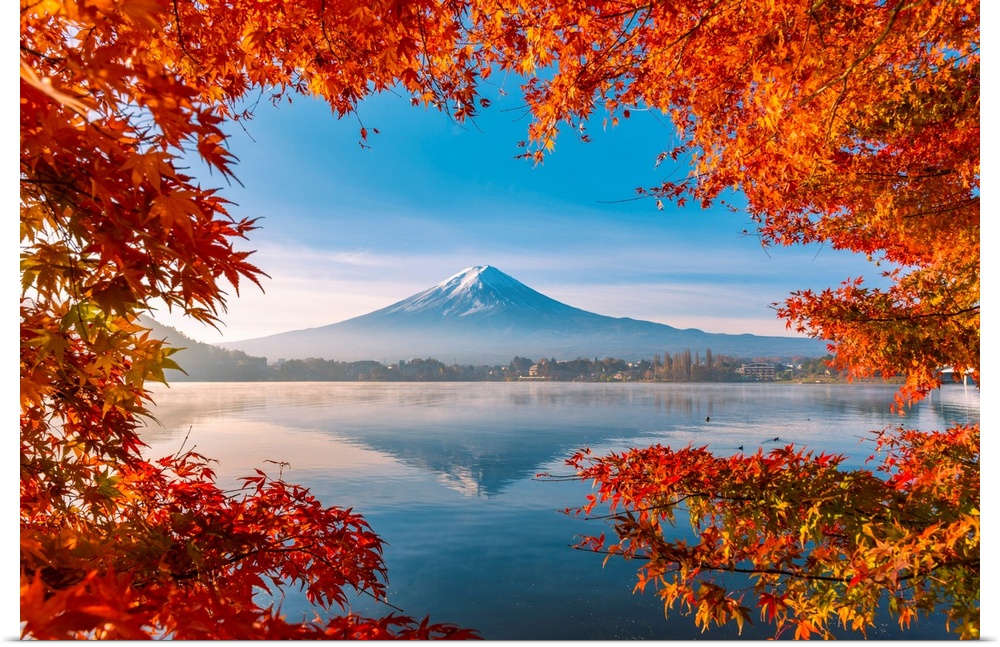 Lake Kawaguchi and Mt Fuji framed by red maple leaves in autumn, Yamanashi Prefecture, Japan.