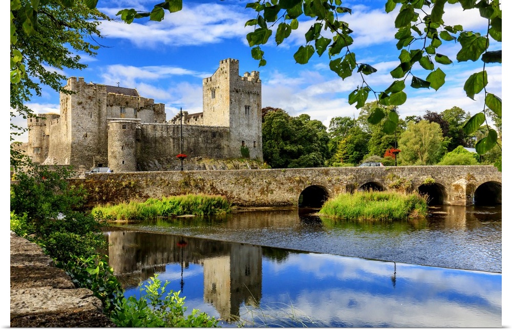Europe, Ireland, Caher, Tipperary, medieval town of Caher with fortress and bridge reflecting in the river
