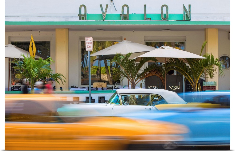 U. S. A, Miami, Miami Beach, South Beach, Ocean Drive, Traffic passing Yellow and white vintage car parked outside Avalon ...