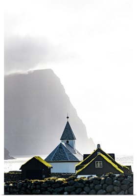 Misty Sky Over The Church Of Vidareidi Ovelooking A Fjord, Vidoy Island, Faroe Islands