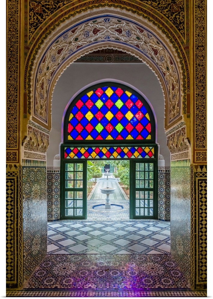 Morocco, Marrakech-Safi (Marrakesh-Tensift-El Haouz) region, Marrakesh. Interior archway with view to gardens at Bahia Pal...
