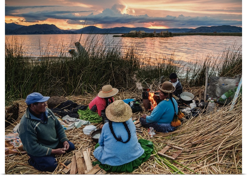 Native Uro Family dining at sunset, Uros Floating Islands, Lake Titicaca, Puno Region, Peru