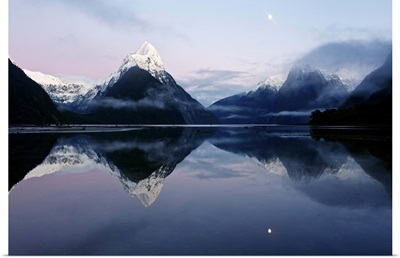 New Zealand, Fiordland, Milford Sound and moon during a cold and misty sunrise