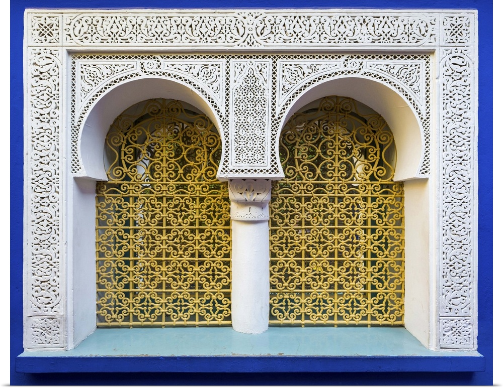 Morocco, Marrakech-Safi (Marrakesh-Tensift-El Haouz) region, Marrakesh. Ornate window against blue wall at Jardin Majorell...