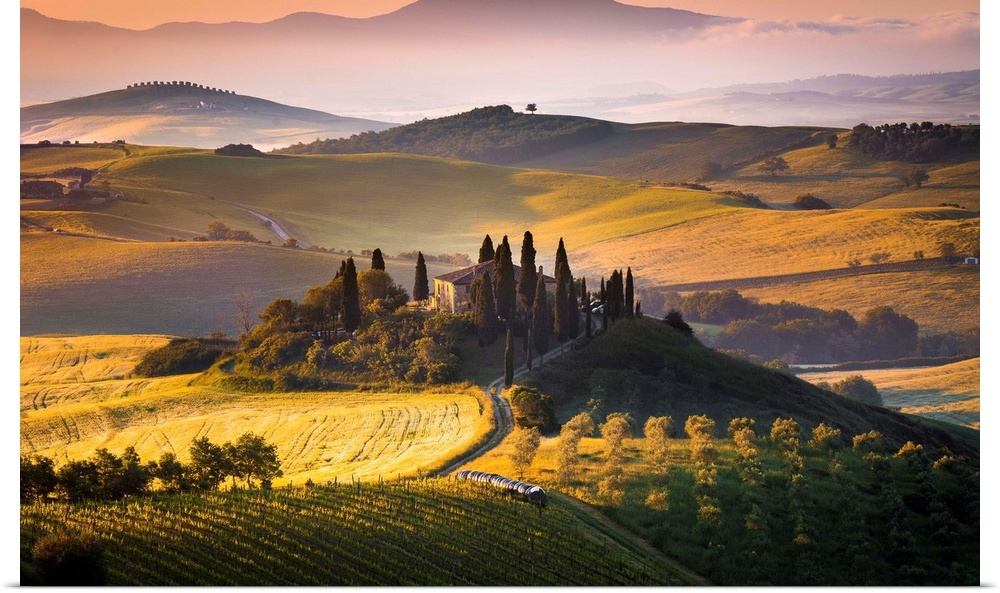 Podere Belvedere, San Quirico d'Orcia, Tuscany, Italy. Sunrise over the farmhouse and the hills.