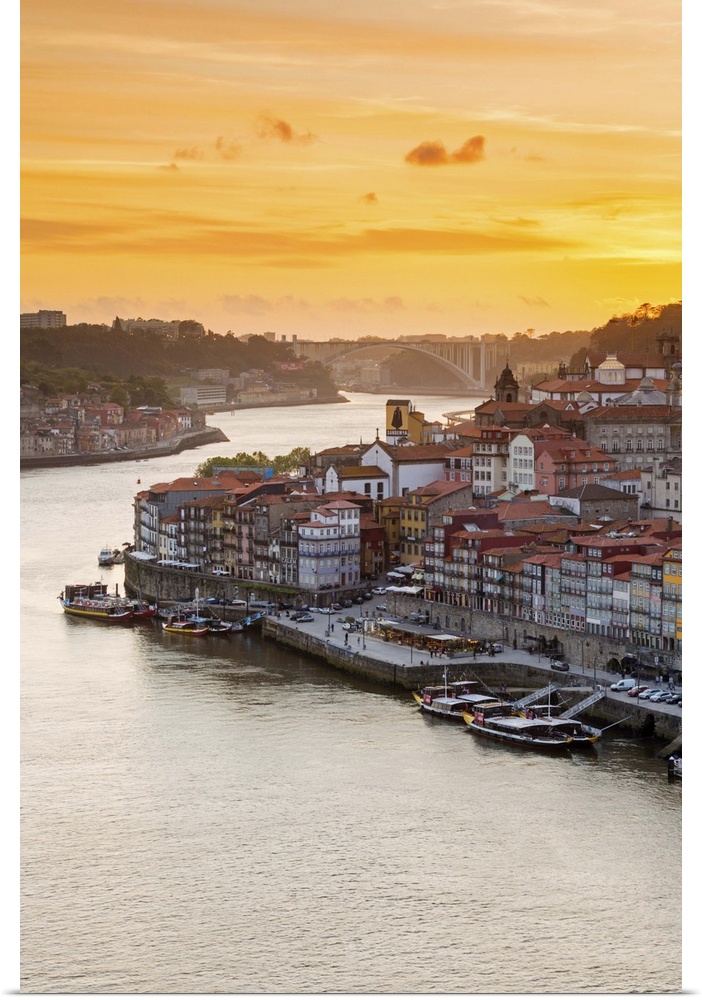 Portugal, Douro Litoral, Porto. Sunset over the UNESCO listed Ribeira district, viewed from Dom Luis I bridge.