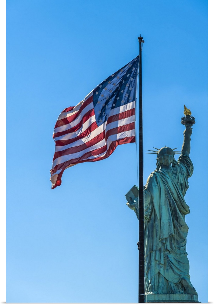 Rear side of Statue of Liberty with US flag, Liberty Island, New York, USA