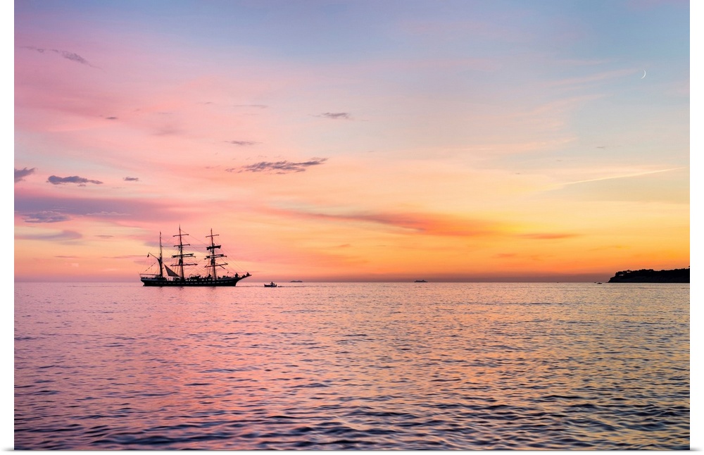 Silhouette of sailing ship at sunset off the coast of Cassis, Bouches-du-Rhone, Provence-Alpes-Cote d'Azur, France.