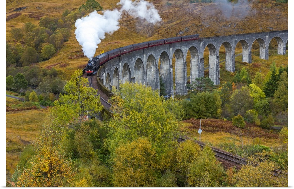 Jacobite steam train crossing Glenfinnan viaduct, Lochaber, nr Fort William, Highlands, Scotland, UK