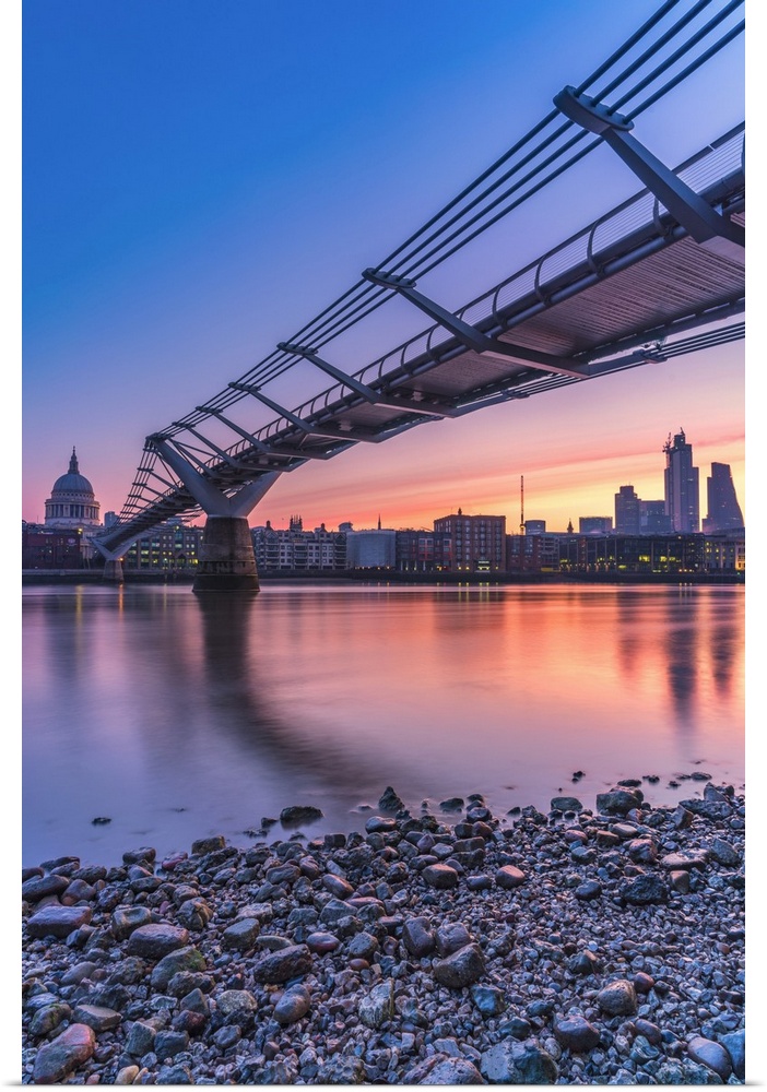 Sunrise over Millennium Bridge, St Paul's Cathedral and financial district from banks of River Thames, London, United King...