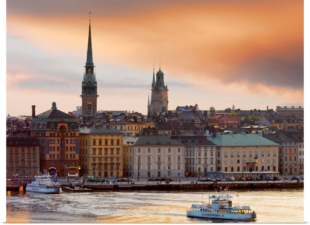 Sweden, Stockholm, Riddarfjarden, Gamla Stan; passenger ferries in bay at dusk.