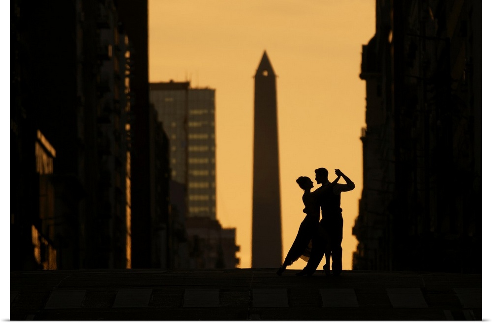 A couple of Professional Tango dancers on Avenida Corrientes at sunset, with the Obelisk monument in the background. Bueno...
