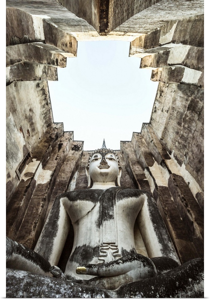 Thailand, Sukhothai Historical Park. Wat Si Chum temple with giant Buddha statue, low angle view
