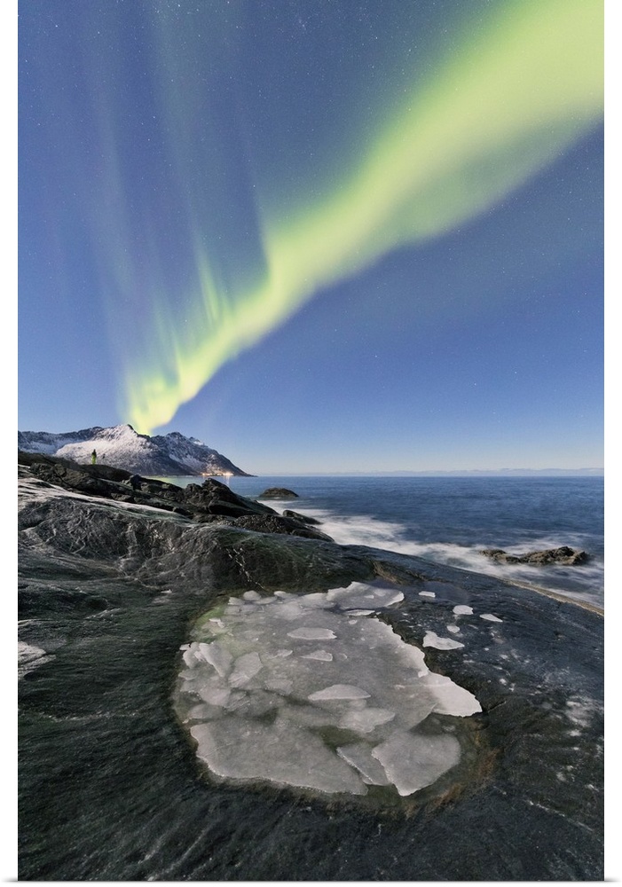 The Northern Lights illuminates the rocky peaks and icy sea in the polar night Tungeneset Senja Tromso Norway Europe