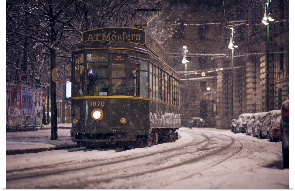 The restaurant tram "ATMosfera" traveling in Piazza Castello in Milano during a heavy snowfall. Lombardy, Italy