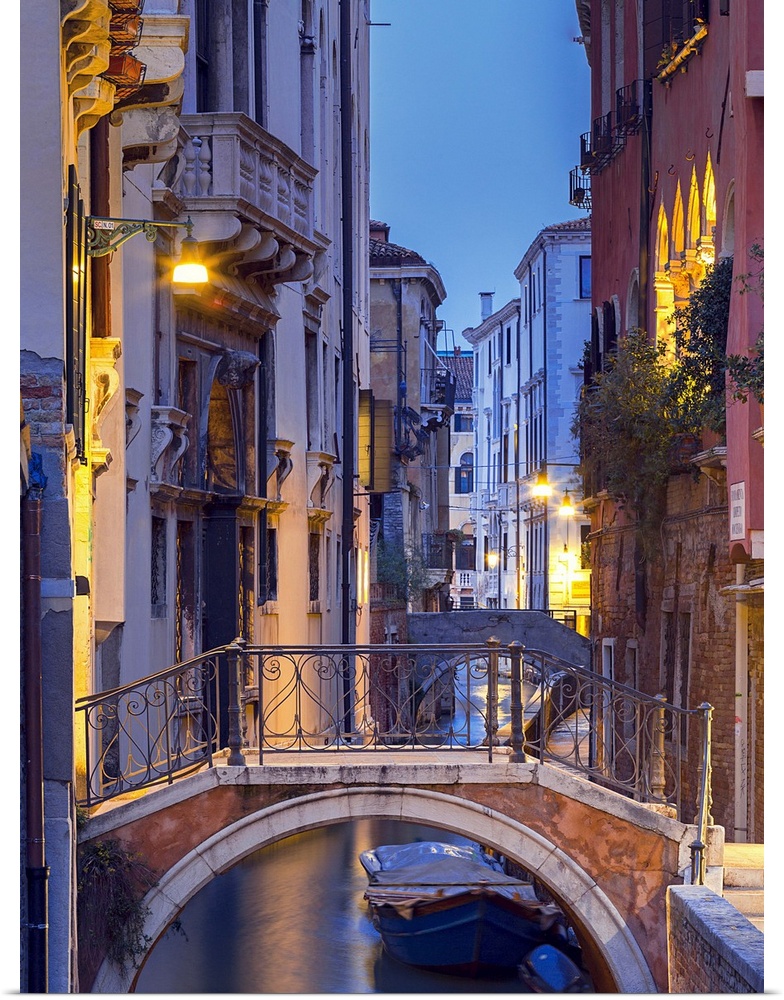 Venice, Veneto, Italy. View over a bridge and a canal at dusk.