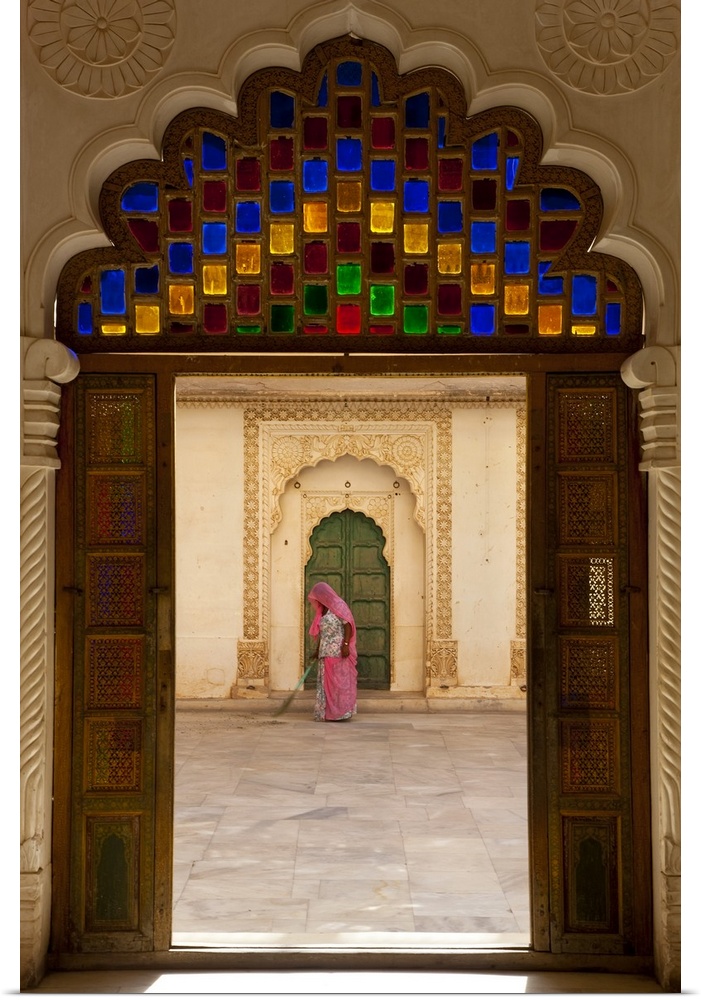 View through doorway of woman sweeping, Meherangarh Fort, Jodhpur, Rajasthan, India
