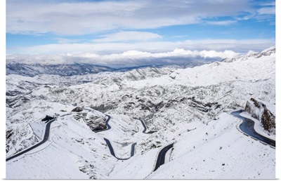 Winding road through Tizi N'Tichka pass in the Atlas Mountains during winter snow