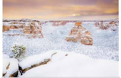 Sun rises over the landscape of fresh snow, Colorado National Monument