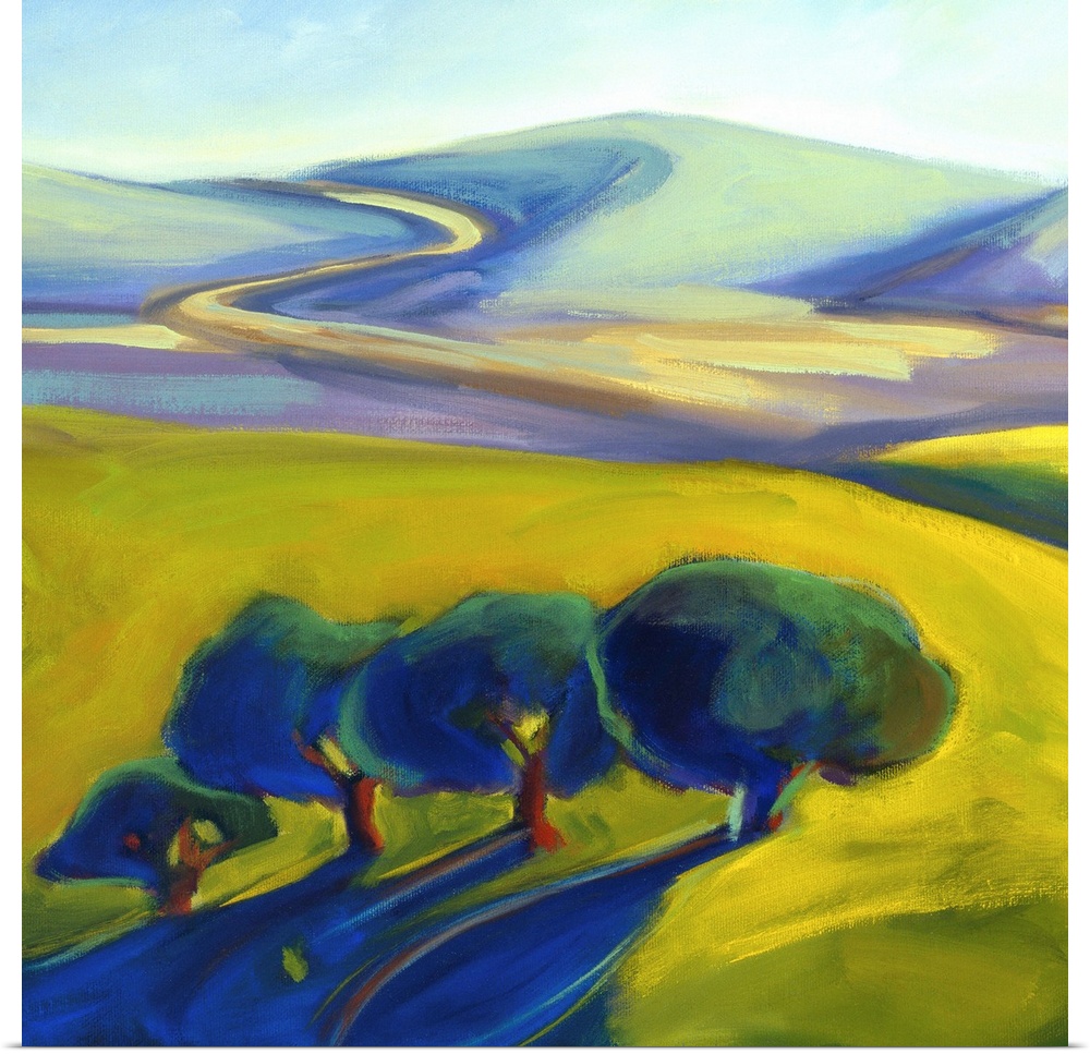 Four trees in the foreground as a winding road disappears over a hill.